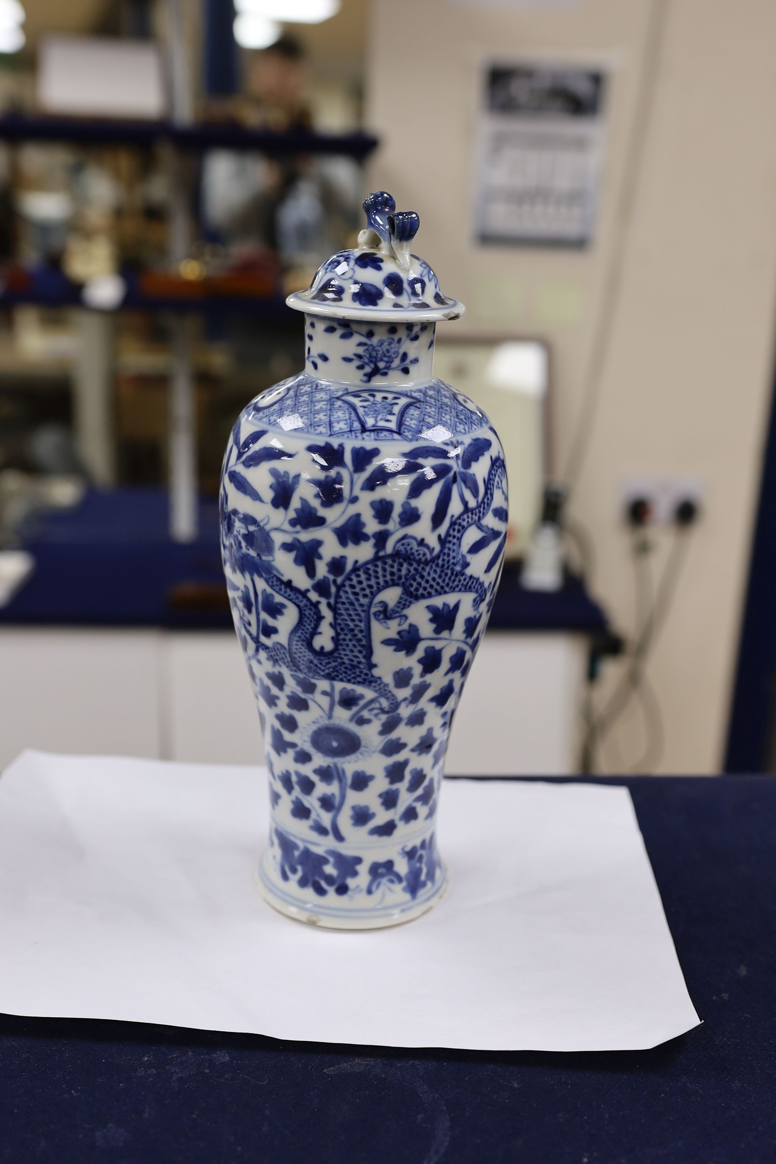 A pair of Chinese blue and white dragon vases and covers, circa 1900. 28cm